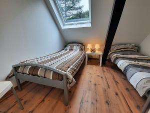 2 Einzelbetten in einem Zimmer mit Fenster in der Unterkunft Cozy holiday home in a unique location in Winterberg in Winterberg