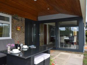 an outdoor patio with a table and a dining area at Lark Rise in Gipping