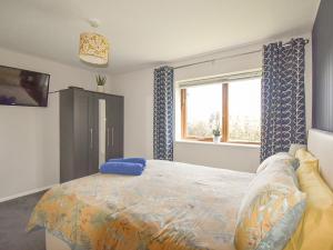 a bedroom with a bed and a window at Lark Rise in Gipping