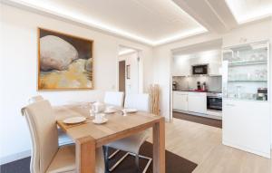 a kitchen and dining room with a wooden table and chairs at Eden in Binz