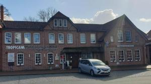 a car parked in front of a brick building at Apartment with Garden and City View in Munster im Heidekreis