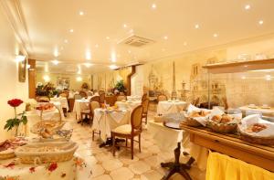 a restaurant with tables and chairs in a room at Hotel Paix Republique in Paris