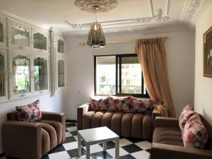 a living room with two couches and a table at Casa lux in Tetouan