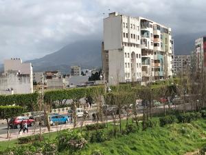 a city with a tall building and a parking lot at Casa lux in Tetouan