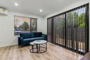 a living room with a couch and a table at Jupiter St Holiday Home No 3 in Auckland