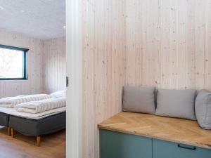 a bedroom with a bed sitting on a wooden shelf at Holiday home Glesborg XCVII in Glesborg