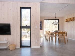 a dining room and living room with a table and chairs at Holiday home Glesborg XCVII in Glesborg