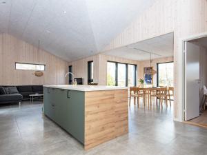 a kitchen and living room with a counter and a table at Holiday home Glesborg XCVII in Glesborg