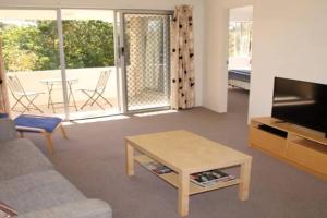 a living room with a couch and a coffee table at Kundu Lodge - Hosted by Burleigh Letting in Gold Coast