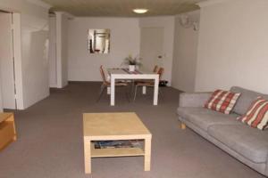 a living room with a couch and a table at Kundu Lodge - Hosted by Burleigh Letting in Gold Coast