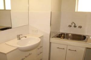 a white bathroom with a sink and a mirror at Kundu Lodge - Hosted by Burleigh Letting in Gold Coast