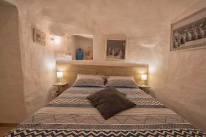 a bedroom with a bed with two pillows on it at Trulli di Puglia - Casa vacanze in Valle d'Itria in Martina Franca