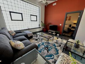 a living room with two couches and a table at Trendy Downtown Apartments in Roanoke