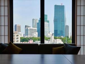 a couch in a room with a view of a city at MIMARU TOKYO AKASAKA in Tokyo