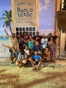 a group of people posing for a picture in front of a hotel at Barco Verde Hostel in Holbox Island