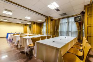 a row of tables and chairs in a room at Hotel Princess in Ourense