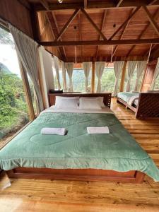 a bedroom with a large bed with two pillows at La Casa de Martin in Baños