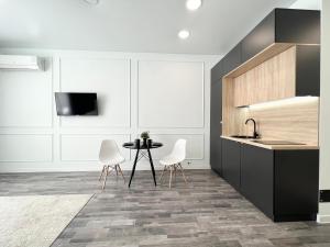 a kitchen with a sink and a table and chairs at Апартаменты в элитном доме. in Pavlodar +8 photos
