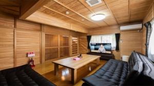 a living room with a couch and a table at YUFUIN O-YADO YUKI ONSEN in Yufuin