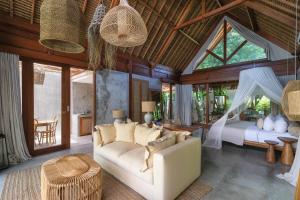 a living room with a couch and a bed at Amaka Villas in Uluwatu +94 photos