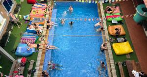 an overhead view of a swimming pool with people in it at The Funky Village in Siem Reap