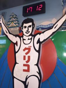 a mural of a football player on a wall at First Cabin Midosuji Namba in Osaka