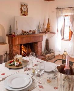 a dining table with a fireplace in a living room at Il Borgo in Subiaco