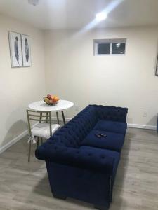 a blue couch sitting in a room with a table at Quite and Spacious Apartment in Elizabeth