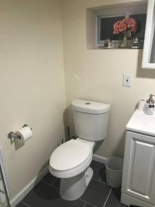 a bathroom with a white toilet and a sink at Quite and Spacious Apartment in Elizabeth