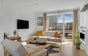 a living room with a couch and a table at Gorgeous Home In Kbenhavn S With Kitchen in Copenhagen