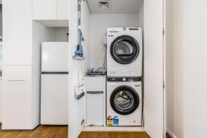 a laundry room with a washer and dryer at In the heart of Richmond - 1693 in Melbourne