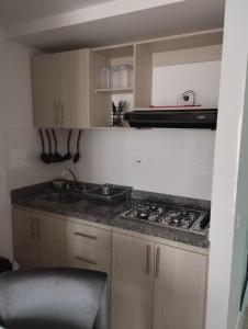 a small kitchen with a sink and a stove at APARTAMENTO EN BUCARAMANGA, ZONA CENTRICA in Bucaramanga