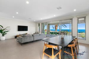 a living room with a table and a couch at Oceanview Escape by Wine Coast Holidays in Port Noarlunga South