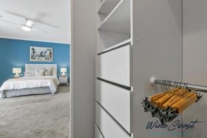 a bedroom with a bed and a door leading to a bedroom at Oceanview Escape by Wine Coast Holidays in Port Noarlunga South