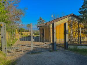 a gate to a building with a yellow door at Casolare del Maestrale - M&M Holiday House in Perugia