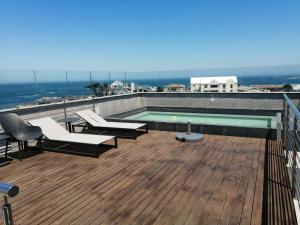 a swimming pool on the roof of a building at Hermanus Waterfront Apartment No.19 in Hermanus