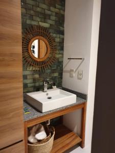 a bathroom with a white sink and a mirror at Mako 54 in Puerto Vallarta