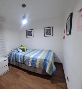 a bedroom with a bed in a white room at Euromarina 2 Reñaca Vista al Mar in Viña del Mar