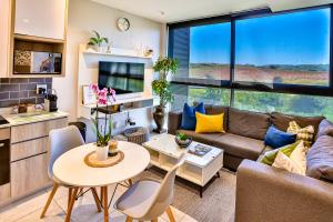 a living room with a couch and a table at Zimbali Lakes Boulevard Suites 103 in Ballito