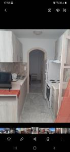 a kitchen with white cabinets and a white refrigerator at Panorama Hotel in Kalymnos