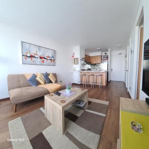 a living room with a couch and a table at Euromarina 2 Reñaca Vista al Mar in Viña del Mar