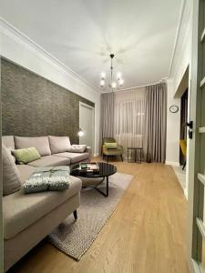 a living room with a couch and a table at Luxury 2 Bedroom Top Central Apartment in Sofia