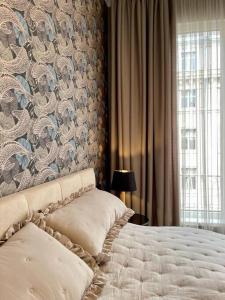 a bedroom with a bed with a floral wall at Luxury 2 Bedroom Top Central Apartment in Sofia