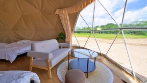 a room with a tent with a chair and a table at glampark Serakoyu Land in Sera