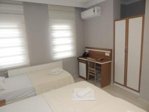 A bed or beds in a room at Sogutpark Hotel