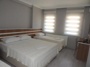 A bed or beds in a room at Sogutpark Hotel