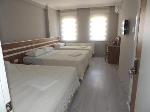 A bed or beds in a room at Sogutpark Hotel