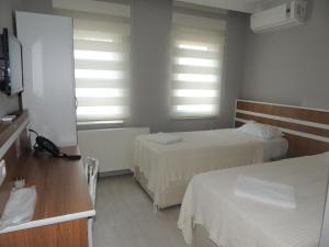 A bed or beds in a room at Sogutpark Hotel