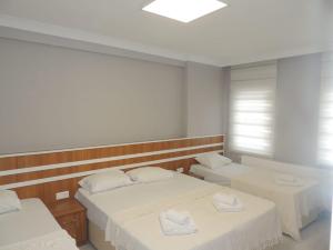 A bed or beds in a room at Sogutpark Hotel