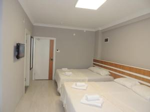 A bed or beds in a room at Sogutpark Hotel